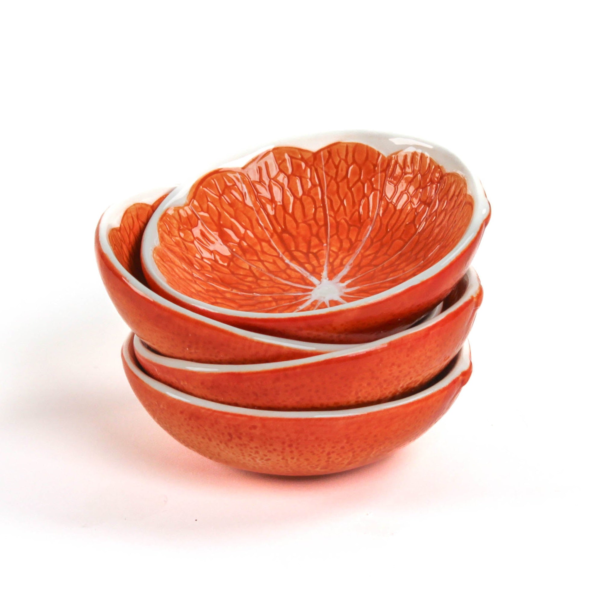 Set of four orange ceramic bowls with a textured design resembling orange fruit on a white background