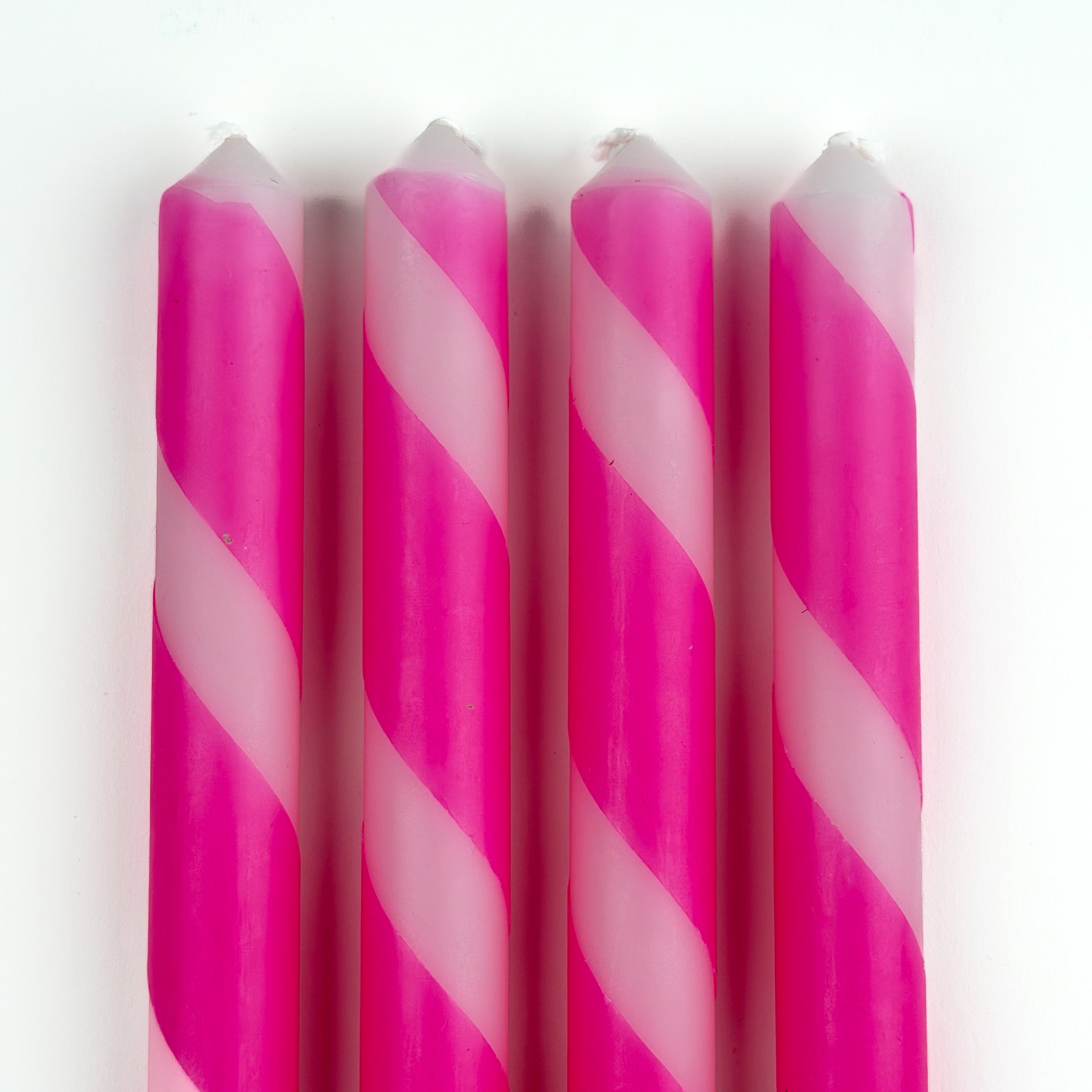 4 pcs of pink and white stripe candles on a white background