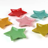 Set of colorful star-shaped dishes on a white background