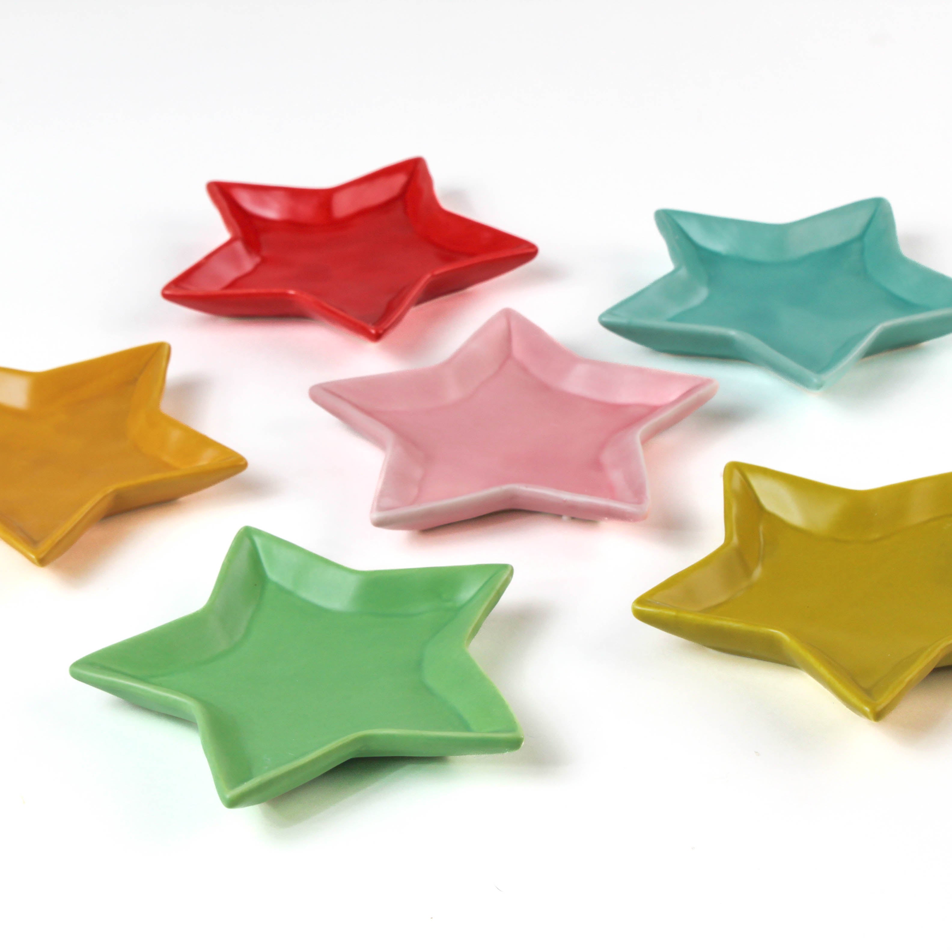 Set of colorful star-shaped dishes on a white background
