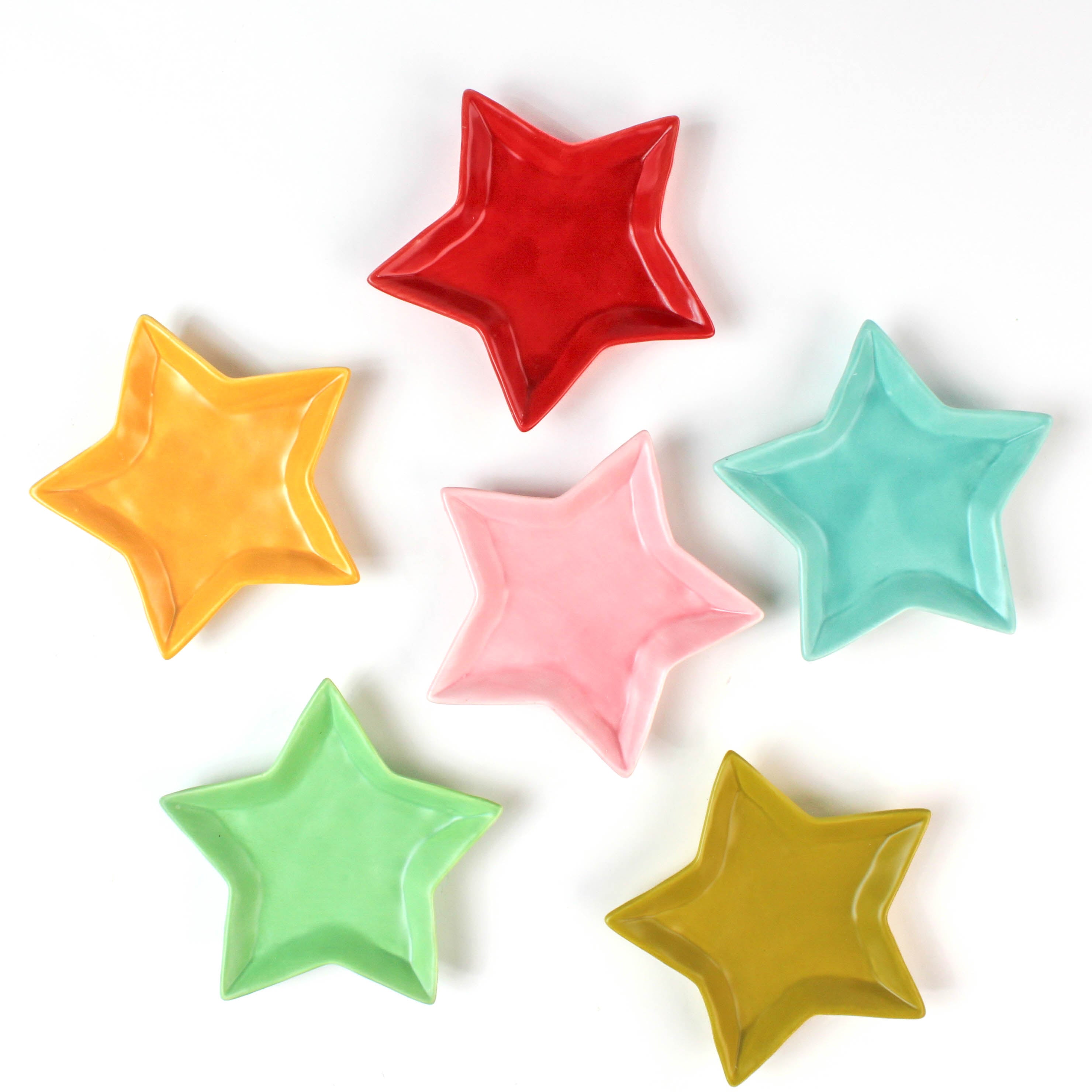 Set of colorful star-shaped dishes on a white background