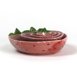 a set of four pink ceramic strawberry dishes in graduating sizes.