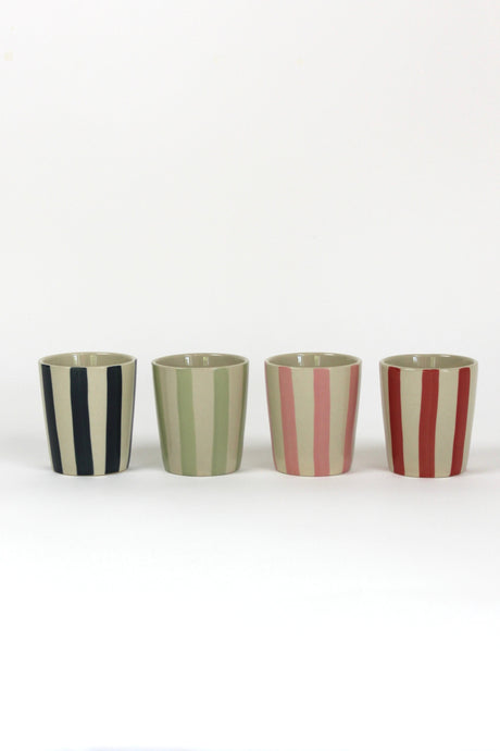 A set of four striped ceramic cups in black, green, pink and red