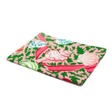 a pink tea towel with colored shells and pink ribbons against a white background 