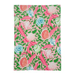 a pink tea towel with colored shells and pink ribbons against a white background 