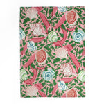 a pink tea towel from madcap cottage patterned with shells, pink ribbons and green leaves. 