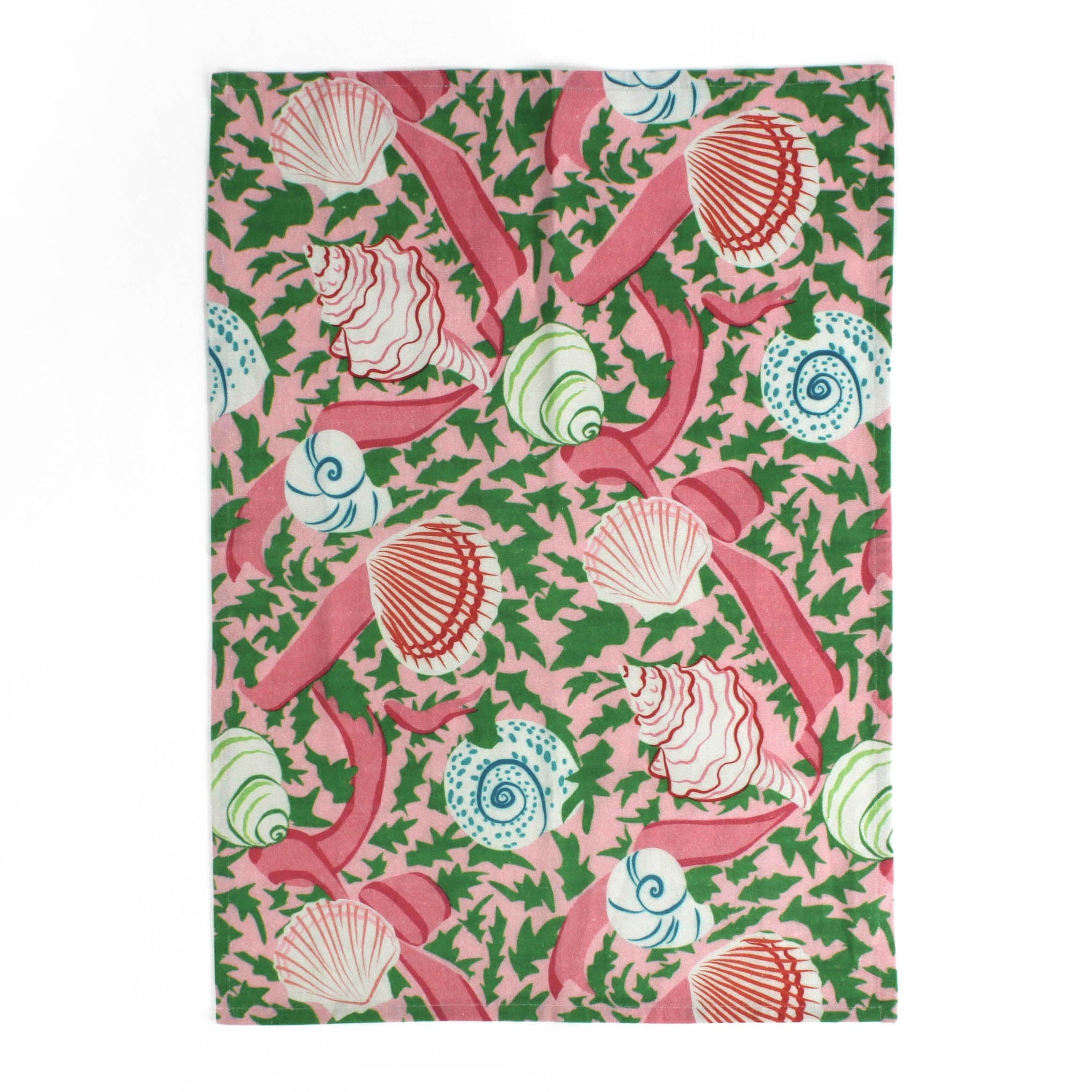 a pink tea towel from madcap cottage patterned with shells, pink ribbons and green leaves. 