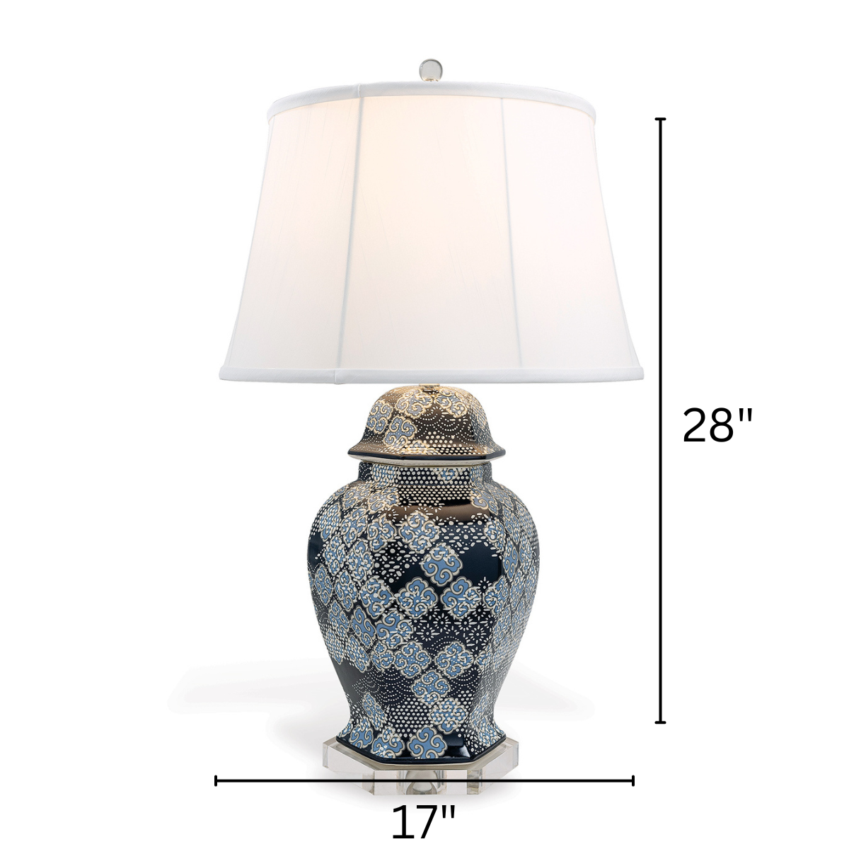 A navy table lamp with a navy blue patterned base and white shade with arrows denoting dimentions 28" x 17"