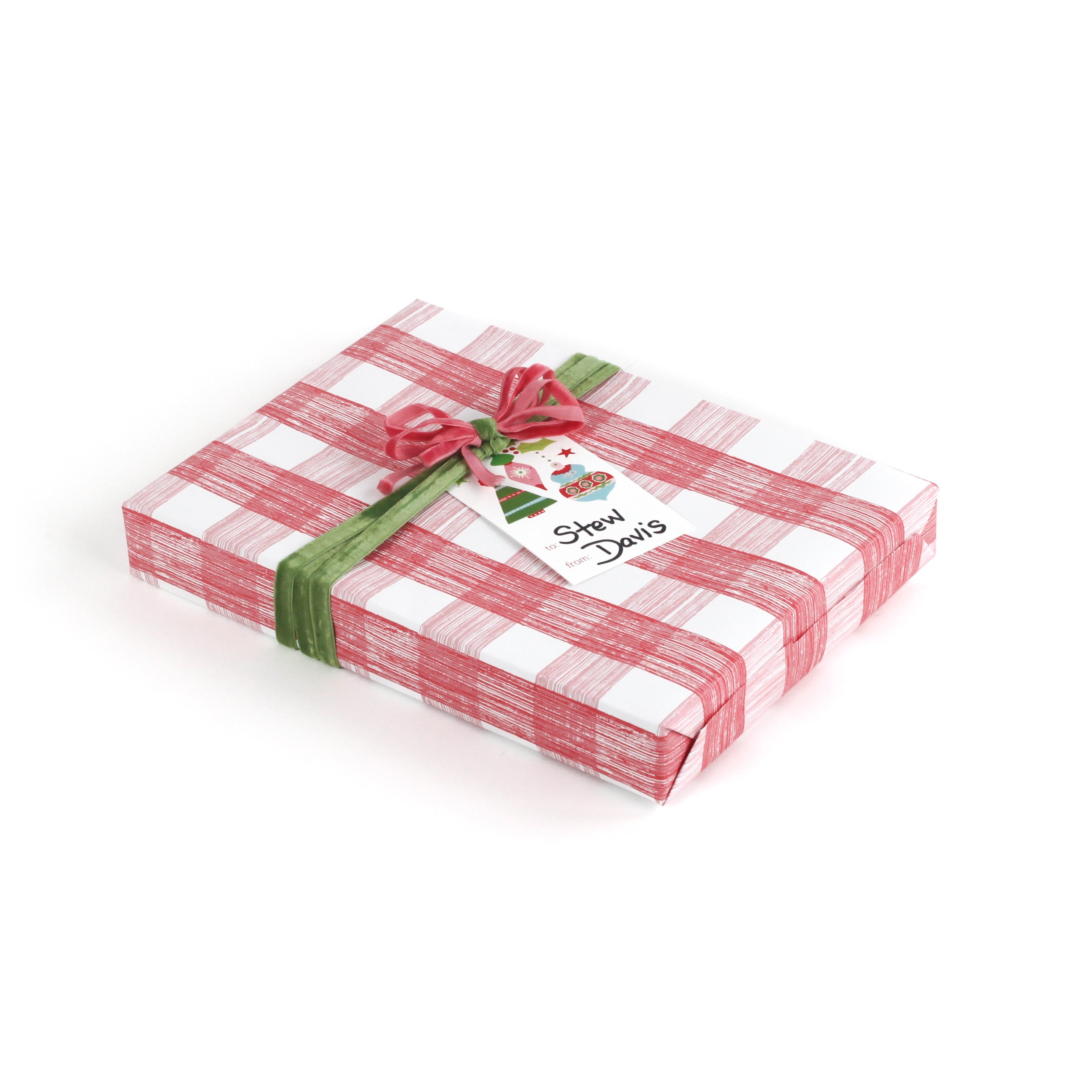 Gift wrapped in red and white gingham paper with green ribbon and Christmas gift tag.