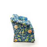 Side of Blue floral upholstered loveseat with botanical pattern and rolled arms