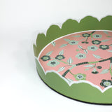 Side detail view of Temple Garden, a tole metal tray with scalloped edges in green with a pink and green chinoiserie peony blossom pattern