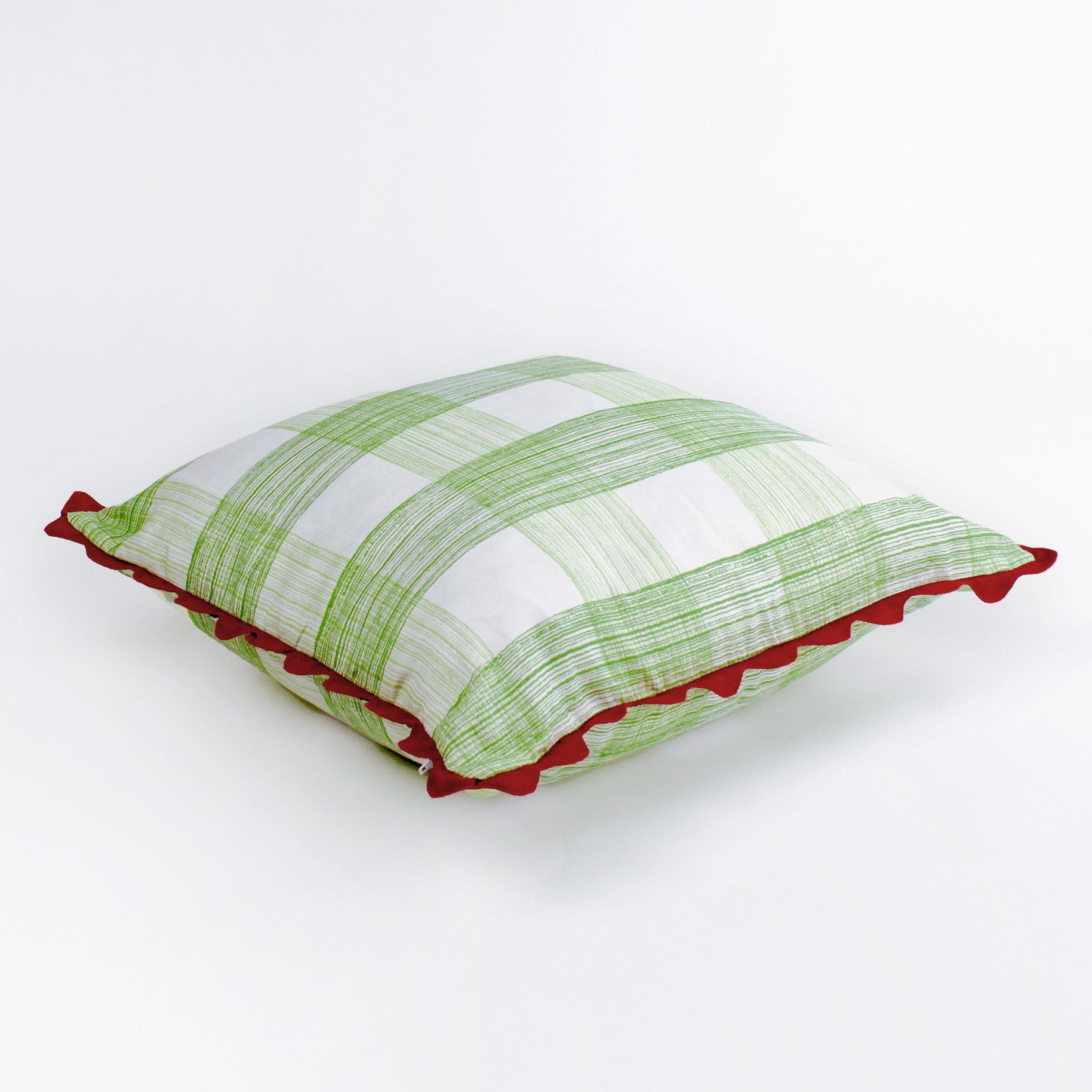 Square decorative pillow with a light green gingham plaid pattern on a white background, finished with a red scalloped trim around the edges.