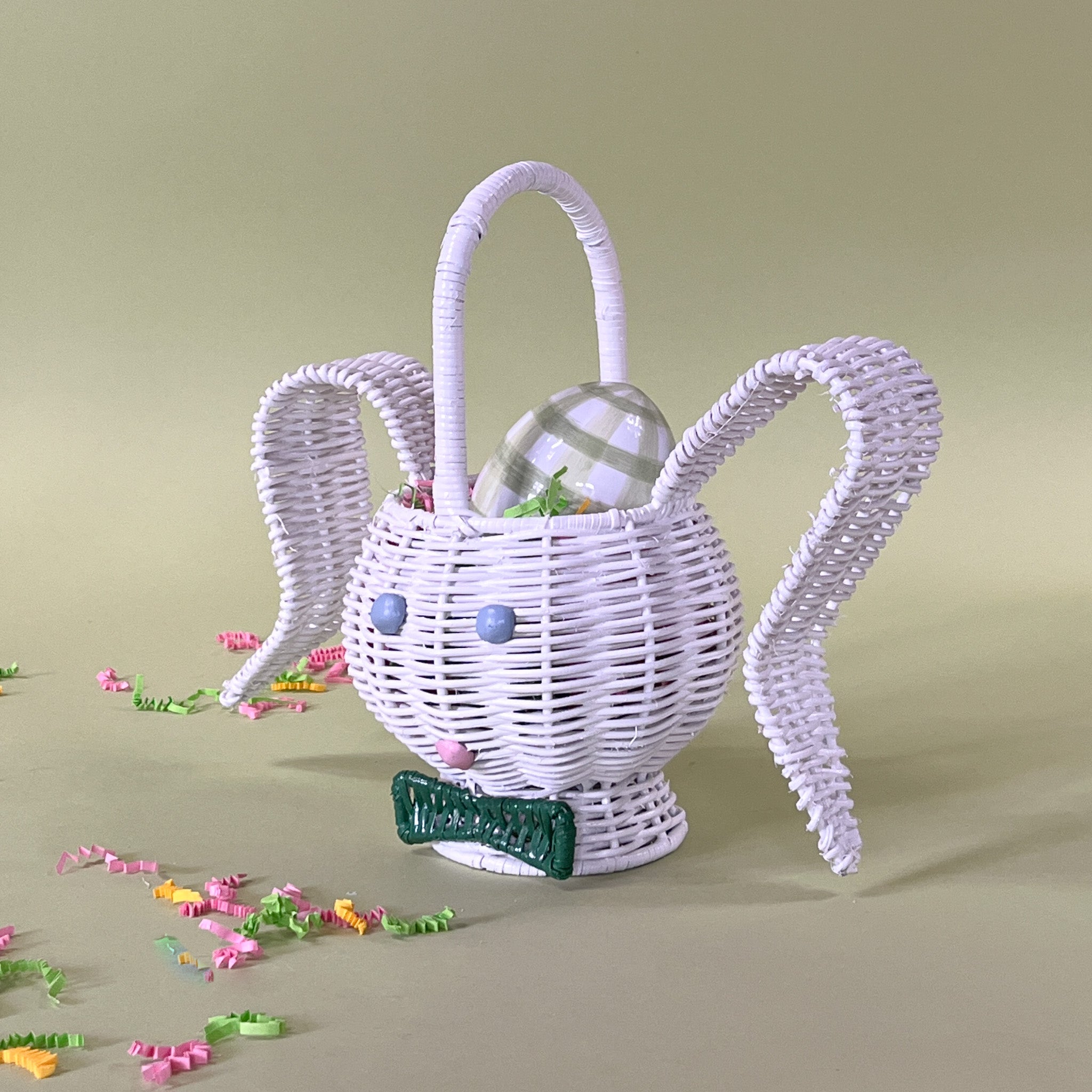 white rattan bunny easter basket with egg in it side view