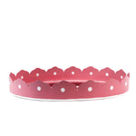 outside of the Hand-Painted Metal Christmas Santa Tray featuring a cheerful Santa Claus face with a red hat on a pink circular background with scalloped edges.