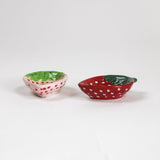 Two small ceramic bowls with a strawberry design and shape on a white background
