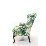 a vintage palm beach armchair covered in palm motif fabric 