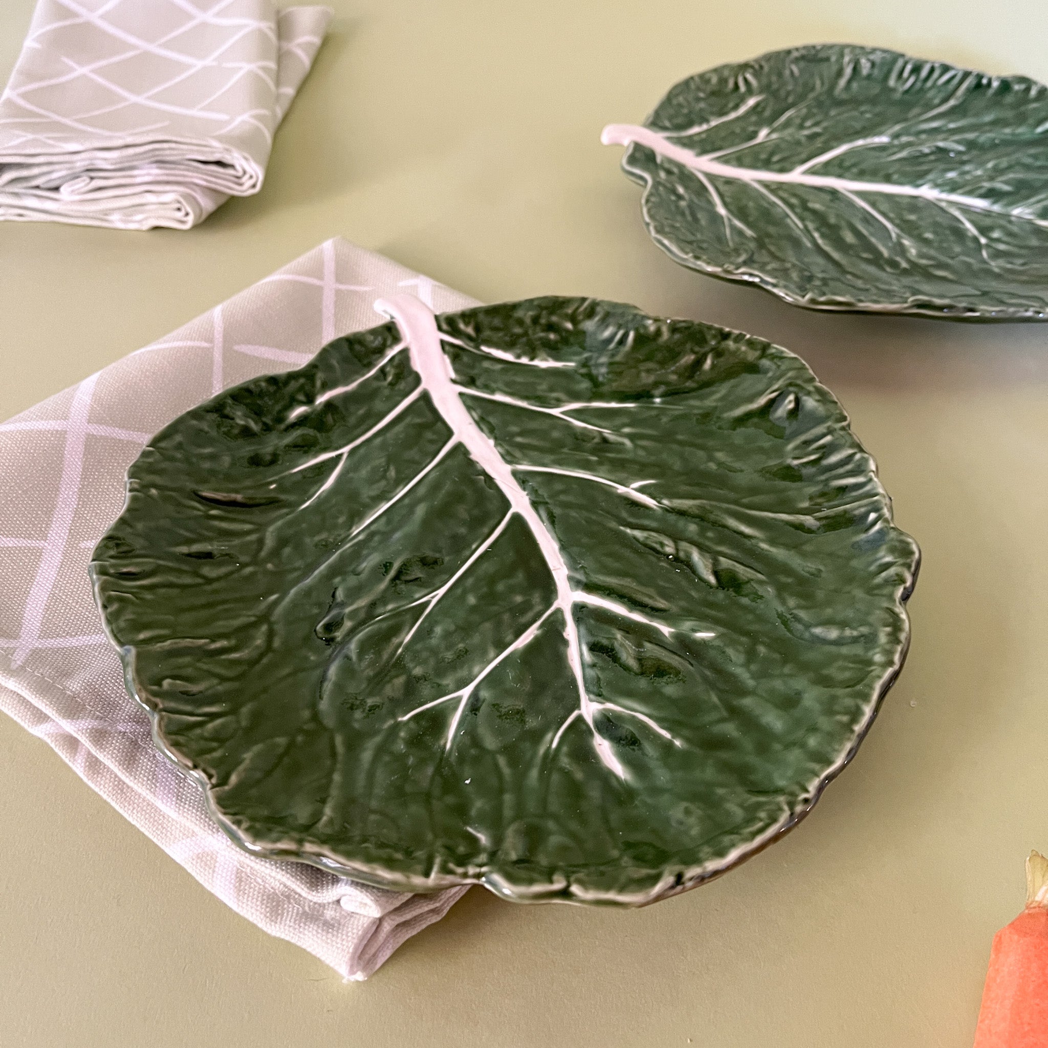 side view of two ceramic cabbage leaf plates from madcap cottage