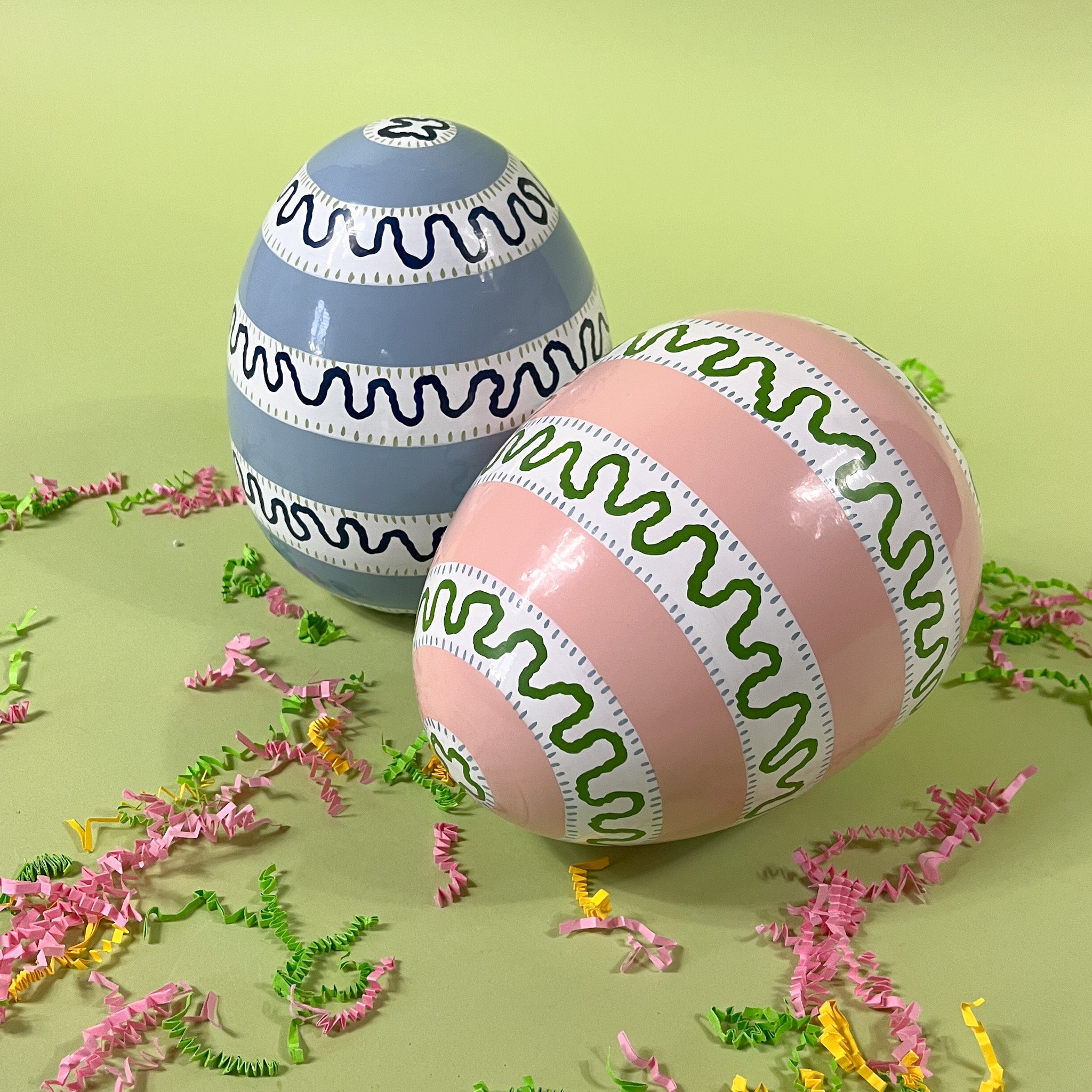 a pink and blue striped set of large decorative easter eggs