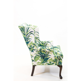a vintage palm beach chair covered in palm motif fabric 