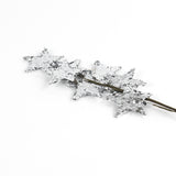 a silver spray of stars on a decorative branch. 