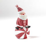 Decorative Santa table decoration on a candy cane with a white background