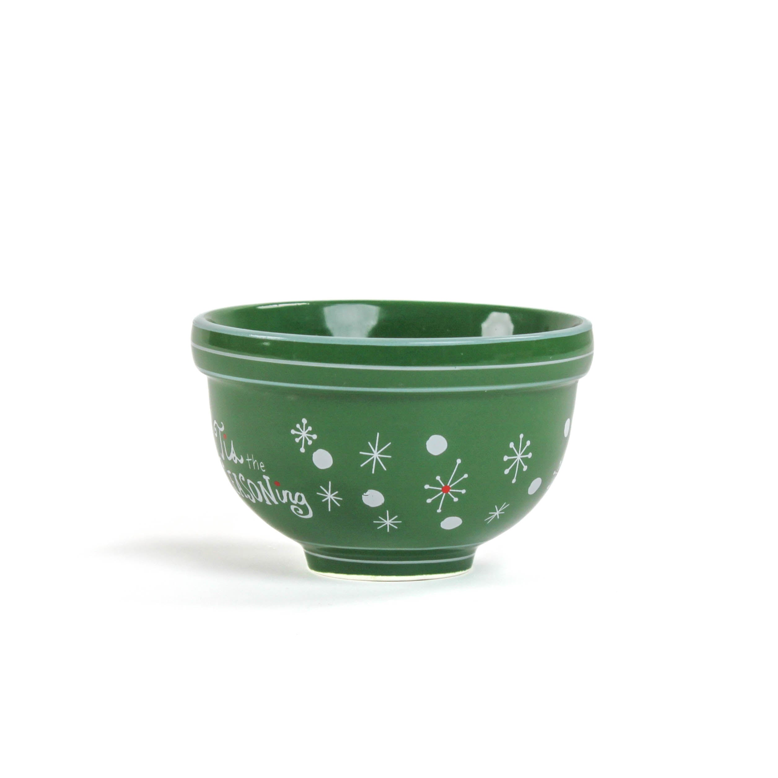 A small green ceramic christmas bowls against a white background. 
