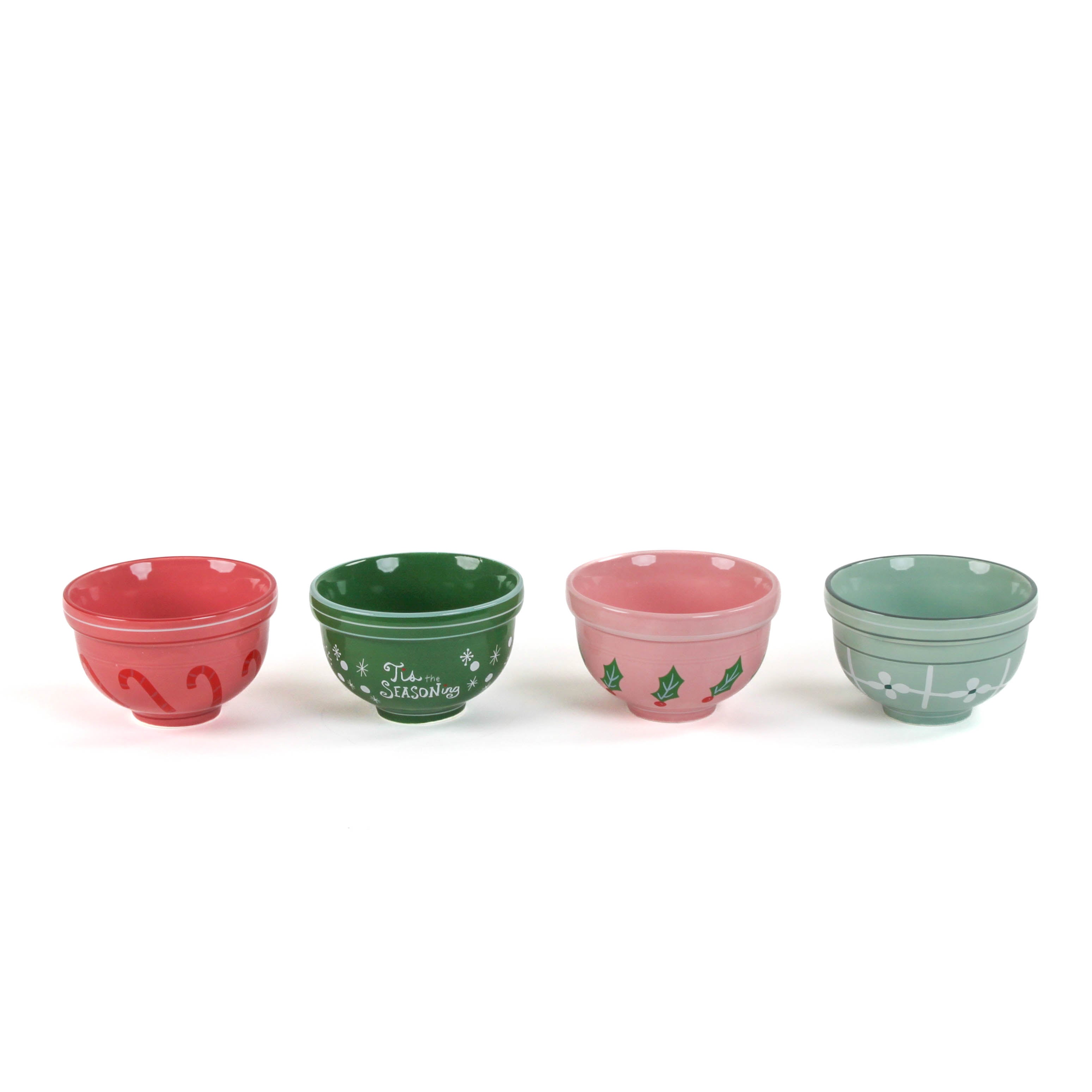 four small ceramic christmas bowls against a white background. 