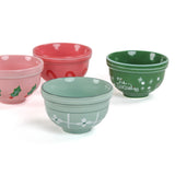 four small ceramic christmas bowls against a white background. 