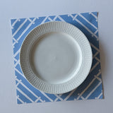 light blue paper placemats with a white bamboo trellis design called "Island House" from Madcap Cottage.