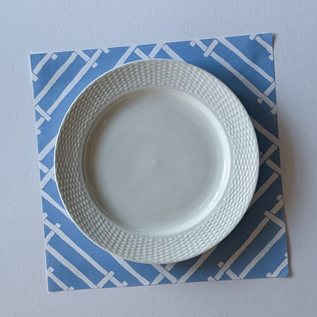 light blue paper placemats with a white bamboo trellis design called "Island House" from Madcap Cottage.