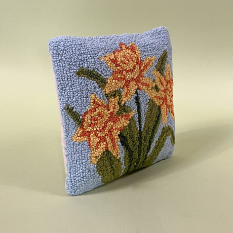 blue spring pillow with yellow daffodils side view