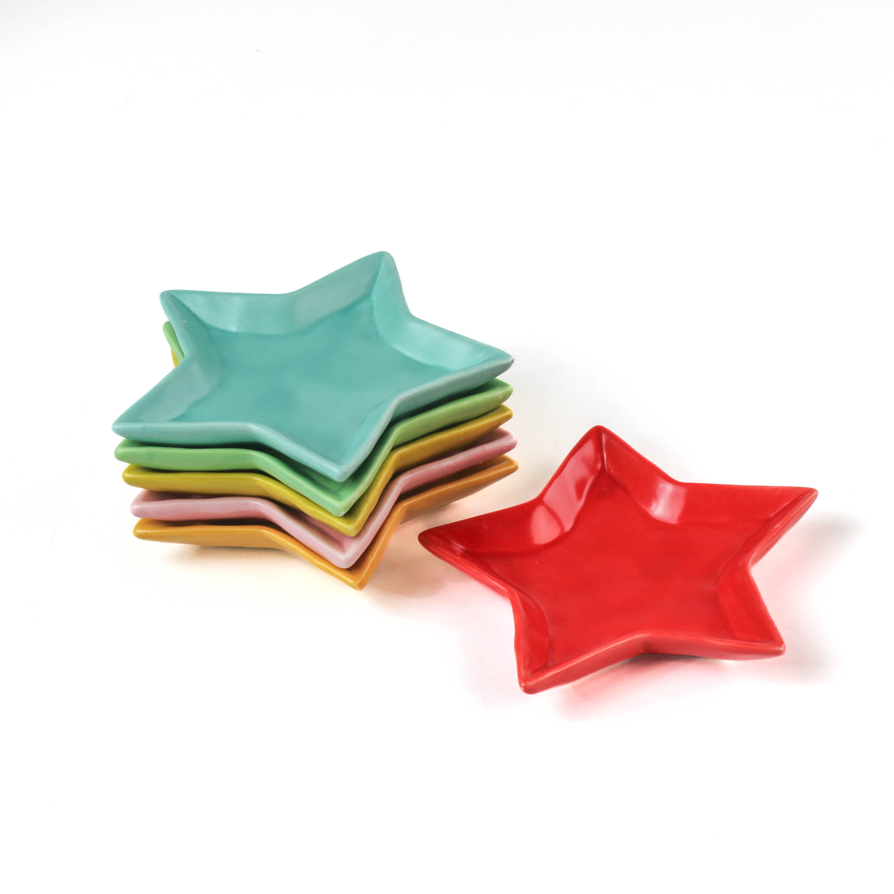 Set of colorful star-shaped plates on a white background