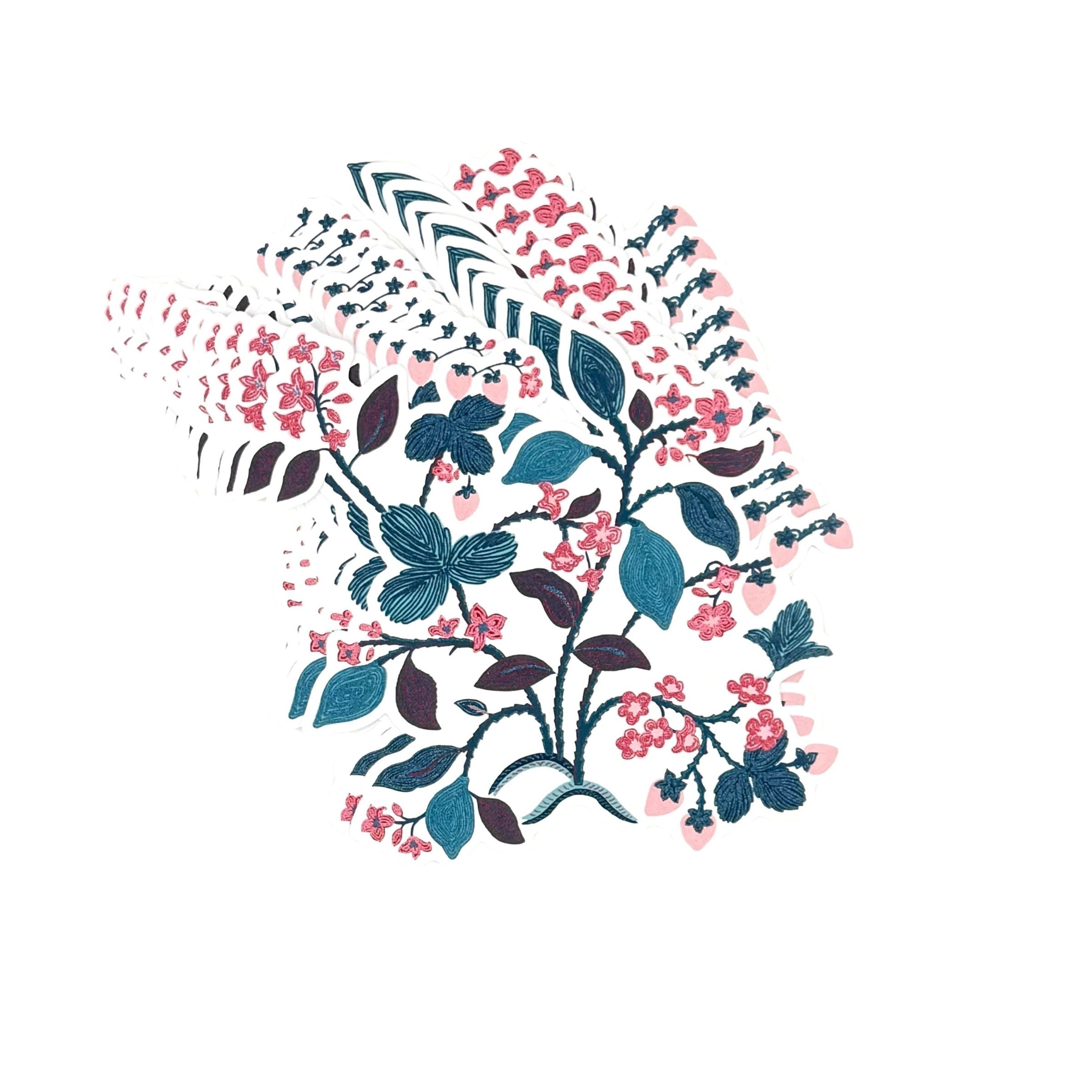 A stacked set of strawberry themed die cut paper placemats featuring floral vines leaves and pink strawberries on a white background.