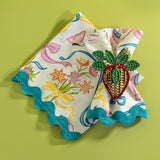 A Bunnies and bow print cloth dinner napkins in multicolor with a strawberry napkin ring against a light green background.