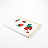 a white strawberry tea towel with a strawberries in the corner and a yellow border around the edges resting on a white background. 