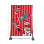 a striped christmas tea towel with four nutcracker motifs and blue and pink tasseled corners and size dimensions noted 24" x 18.5"