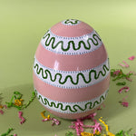 a striped pink large decorative easter egg in tole metal