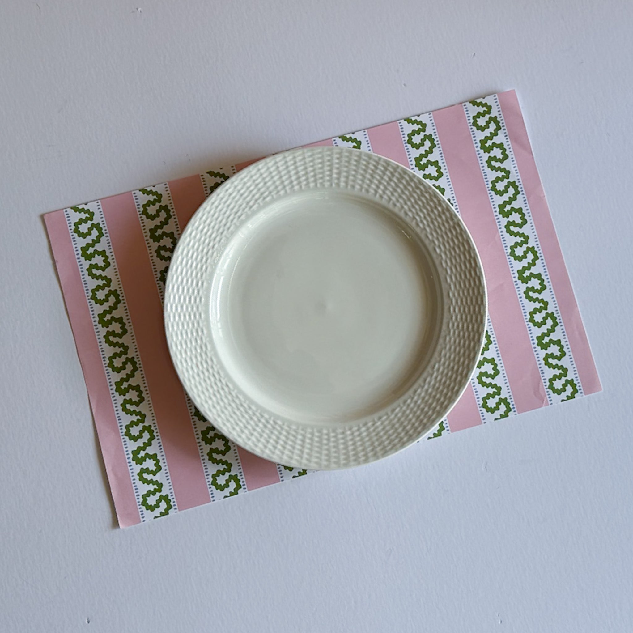 pink paper placemats featuring a striped pattern from Madcap Cottage