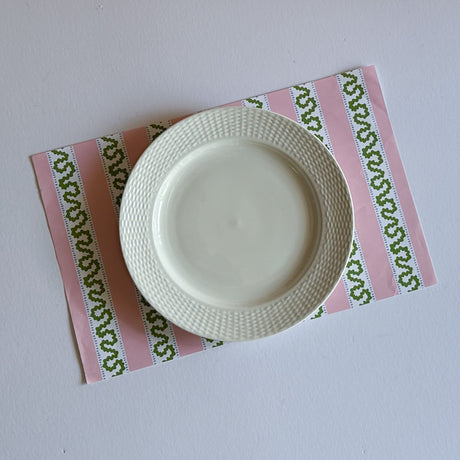 pink paper placemats featuring a striped pattern from Madcap Cottage