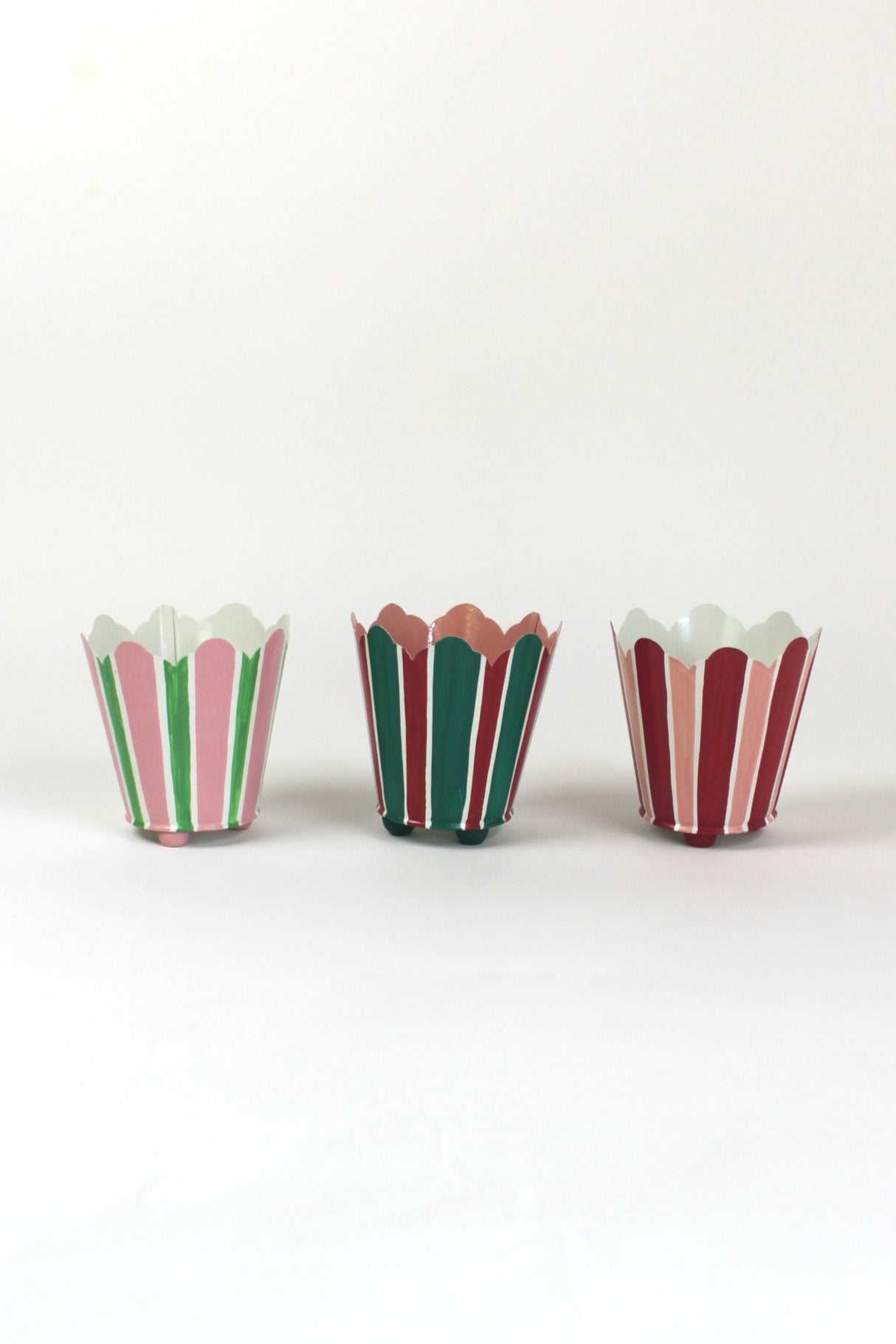 three striped cachepots in shades of pink, red and green from madcap cottage