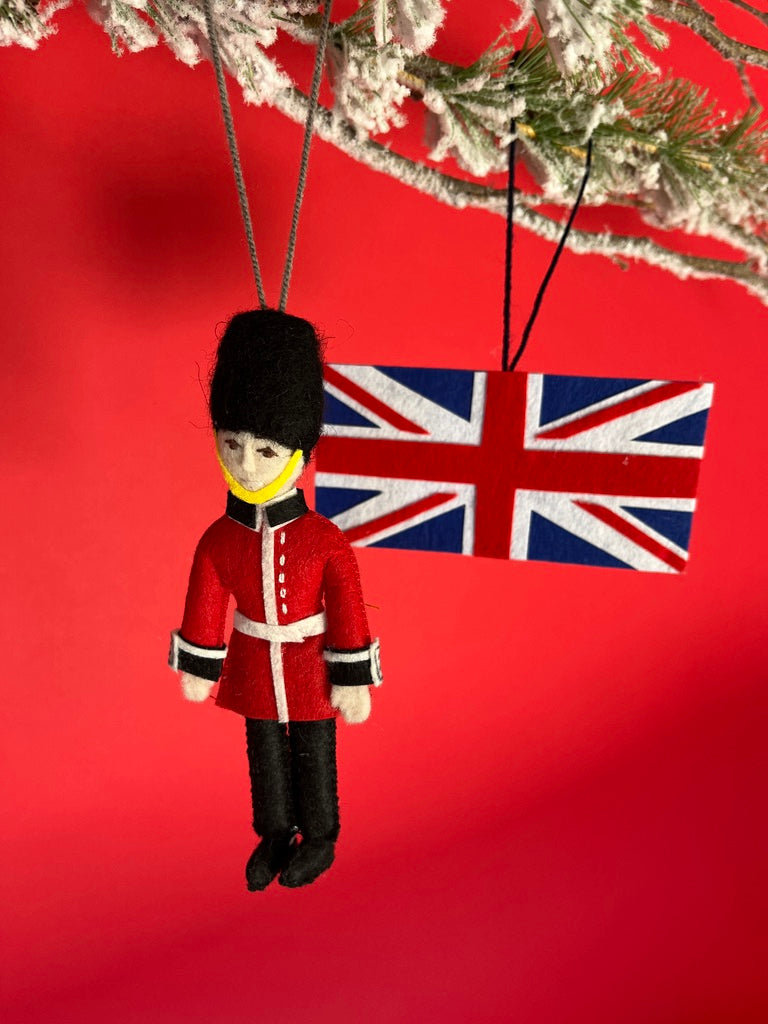 Decorative ornament of a British guard with a Union Jack flag on a red background