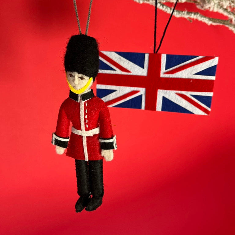 Decorative ornament of a British guard with a Union Jack flag on a red background