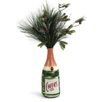 Hand-painted bottle-shaped vase with the word “Cheers,” filled with artificial pine greenery and glittered berry accents.