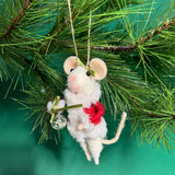 white felt mouse ornament dressed in cozy winter outfit and holding a festive ornament