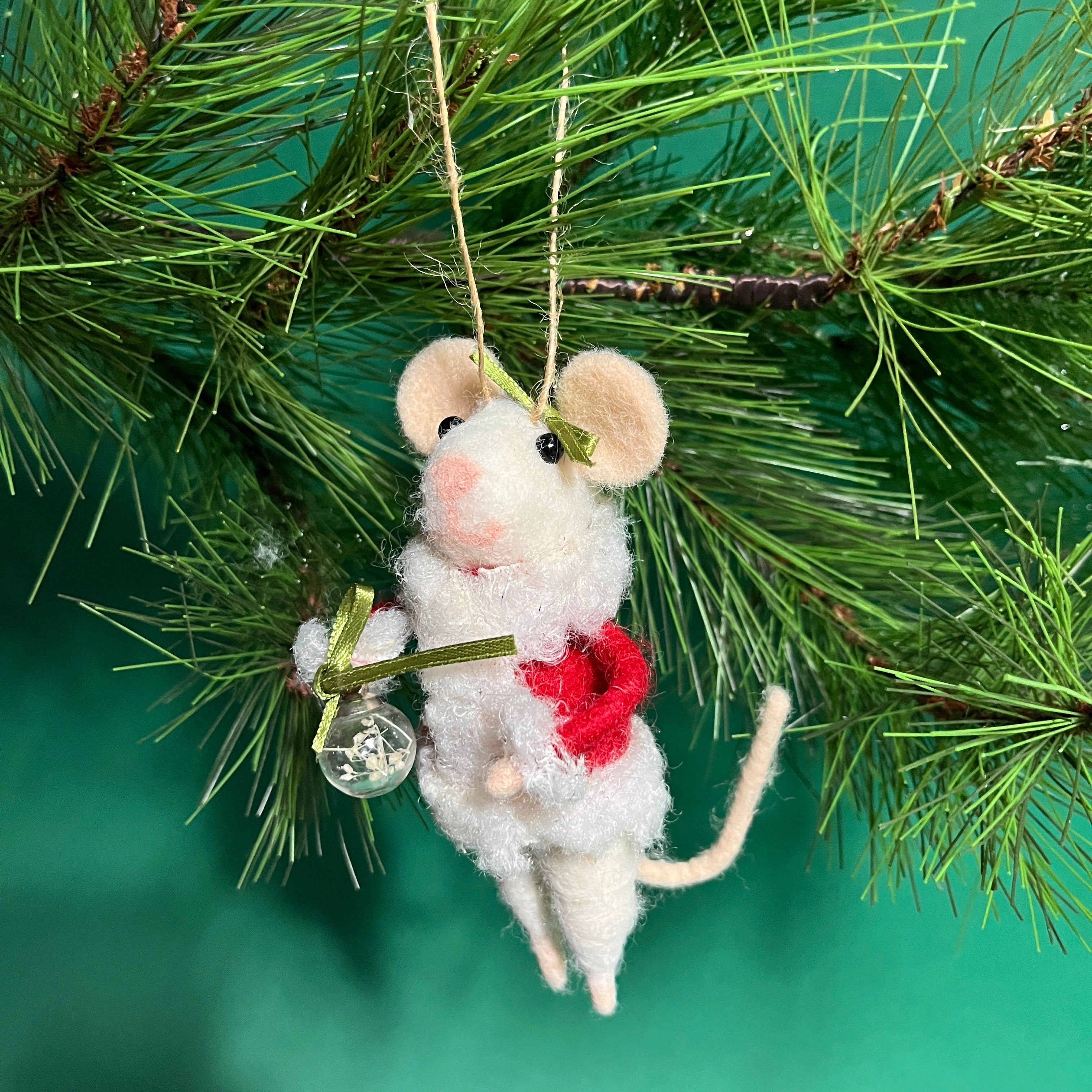 white felt mouse ornament dressed in cozy winter outfit and holding a festive ornament