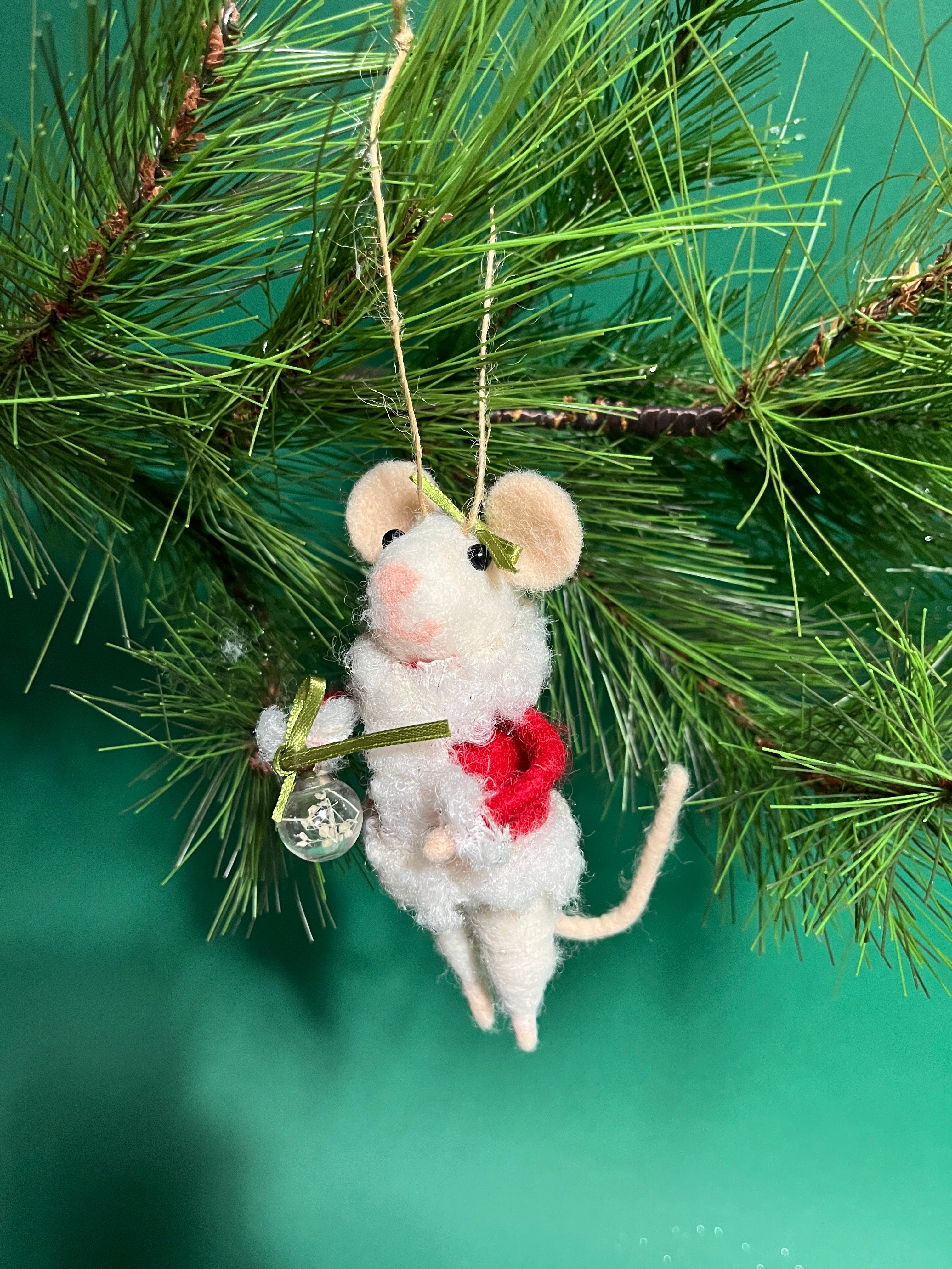 white felt mouse ornament dressed in cozy winter outfit and holding a festive ornament