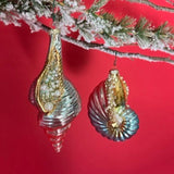 Decorative glass shell ornaments on a branch with a red background