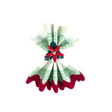 Hand-painted poinsettia napkin ring holding a folded green and red napkin on a white background.