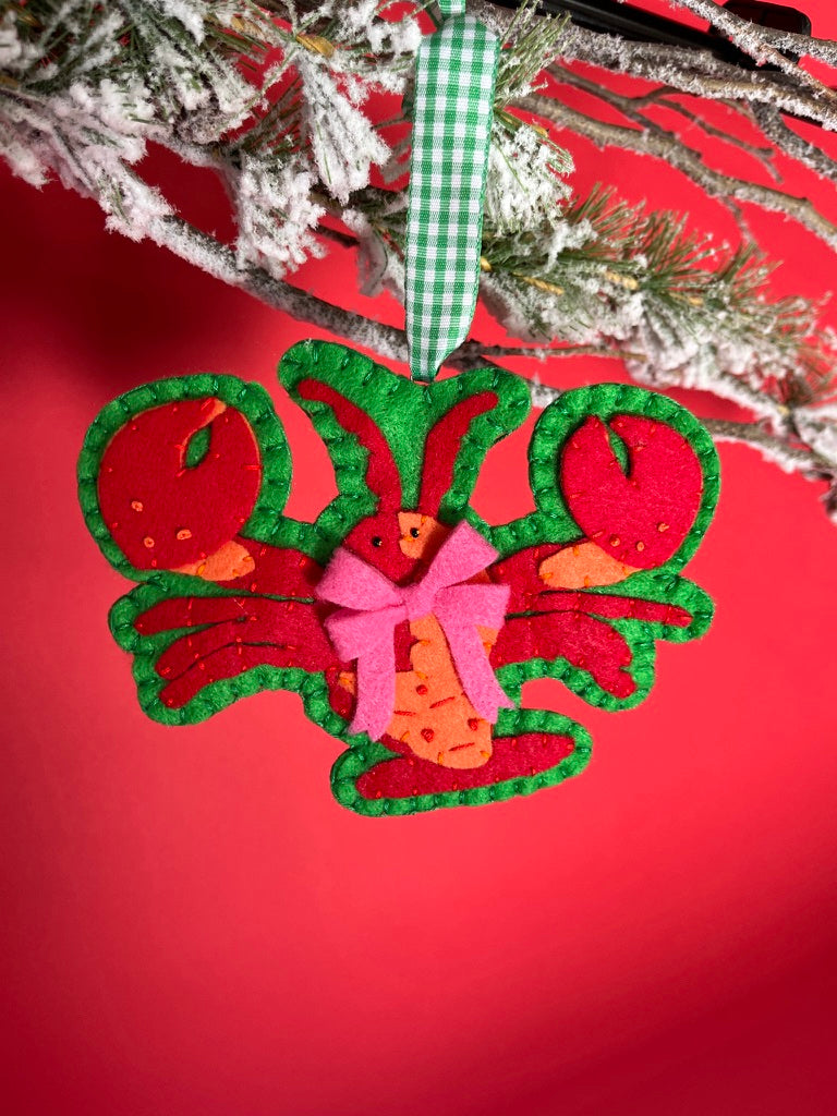 Handcrafted Lobster Felt Christmas Ornament on a red background