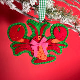 Handcrafted Lobster Felt Christmas Ornament on a red background